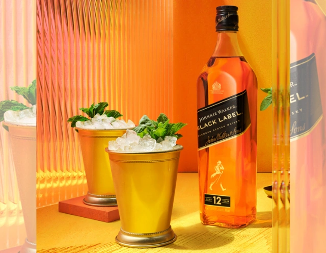 aperol spritz on rock ledge with cutting board of appetizers on bread rounds